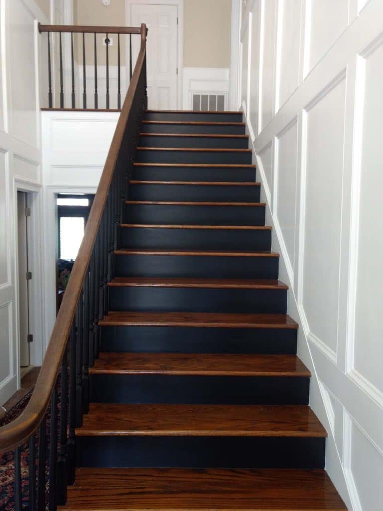 dark brown staircase with white wall